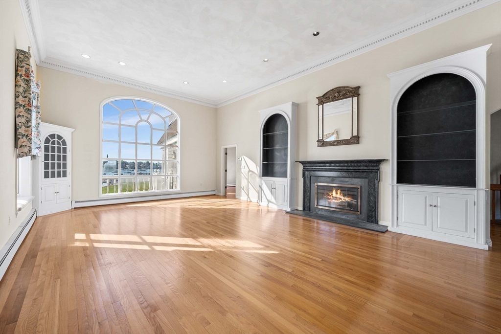 2 Foster Street Marblehead, MA 01945 - Photo 10 of 42 a view of an empty room with wooden floor fireplace and a window