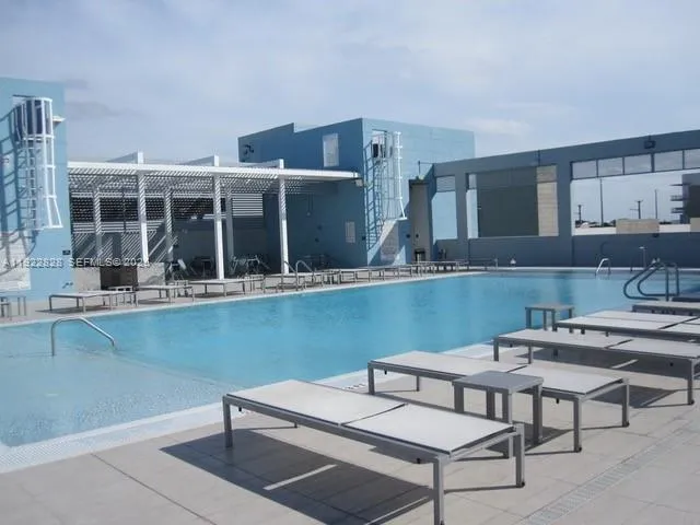 a kitchen with a sink table and chairs