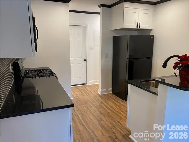 a kitchen with a refrigerator and a stove