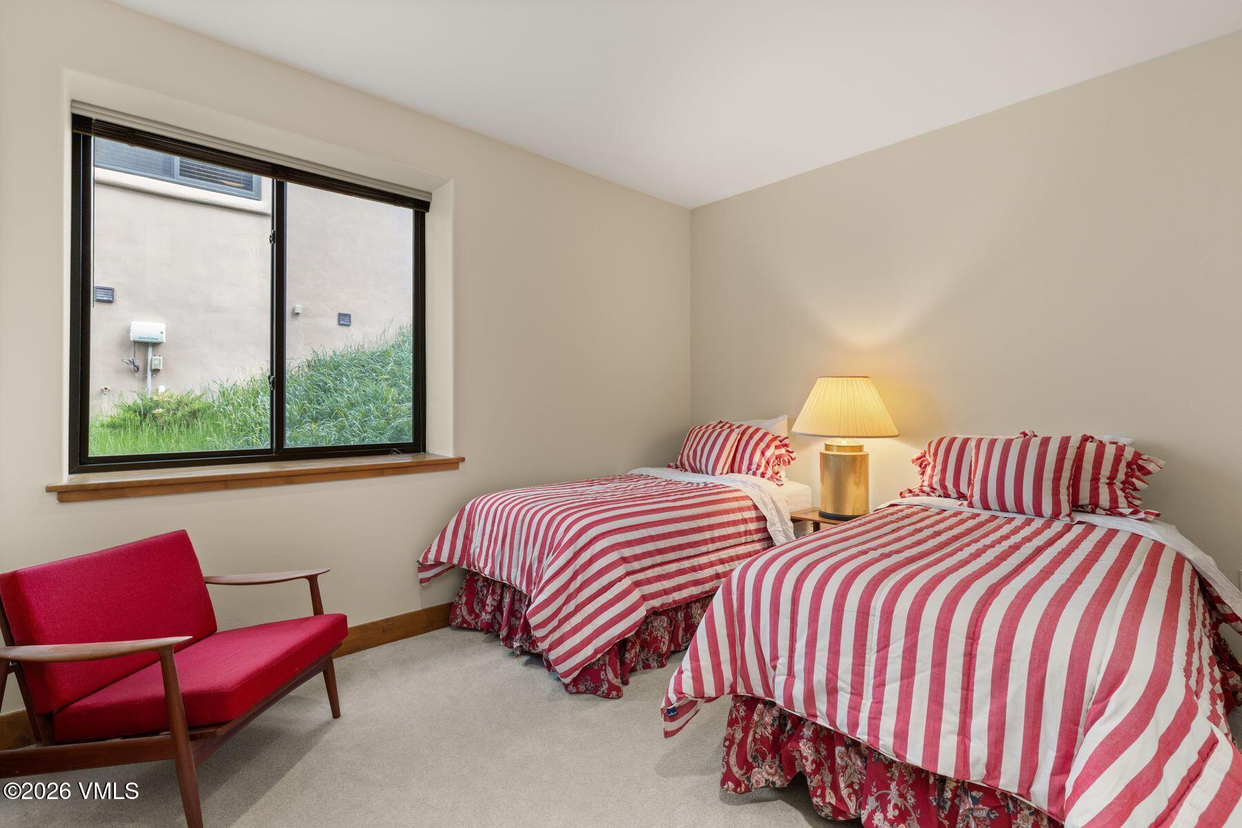 1015 West Wildwood Road, Unit F Avon, CO 81620 - Photo 26 of 35 a bedroom with two beds and a window