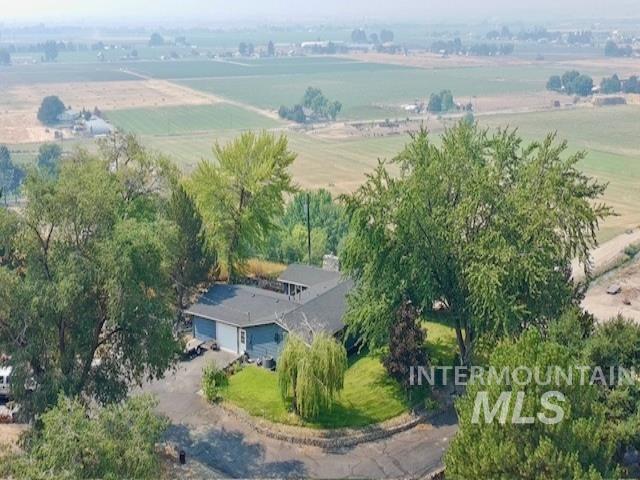 1549 Cove Road Weiser, ID 83672 - Photo 35 of 38 Single-story residence featuring a two-car garage, blue siding, and a dark shingle roof