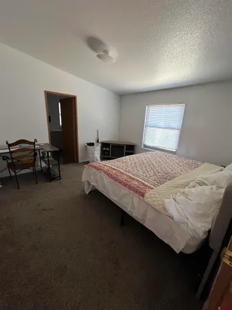 a bedroom with a bed and a chair