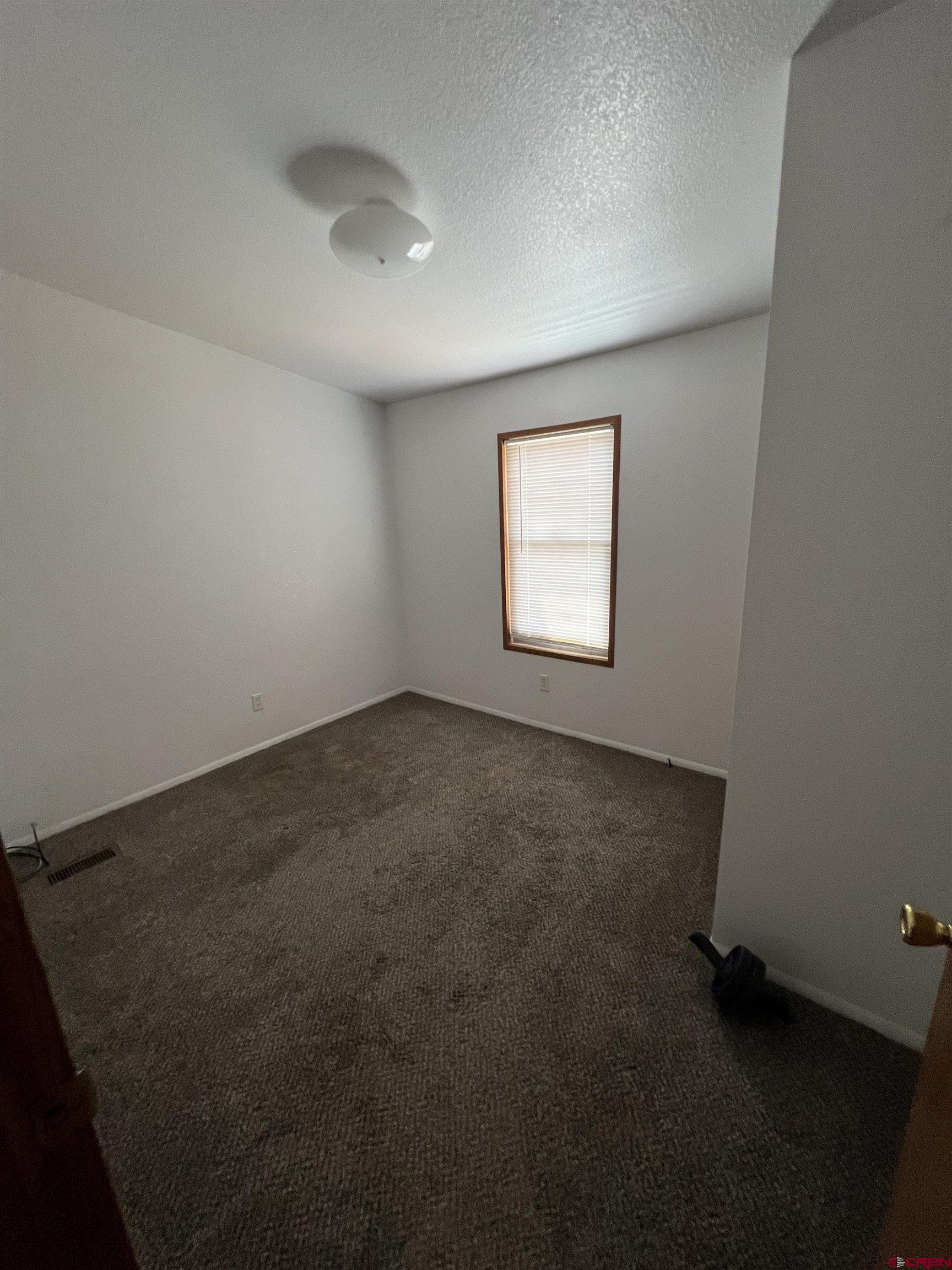 20246 2375th Road Cedaredge, CO 81413 - Photo 15 of 18 an empty room with windows