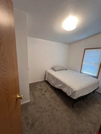 a bedroom with a bed and a night stand