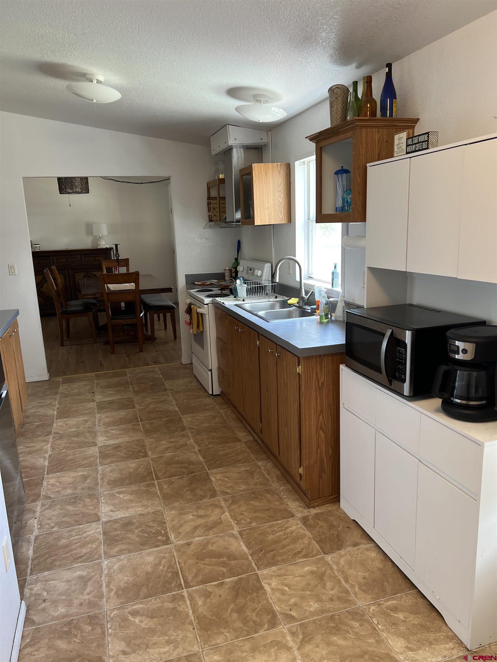 20246 2375th Road Cedaredge, CO 81413 - Photo 7 of 18 a kitchen with a sink and cabinets