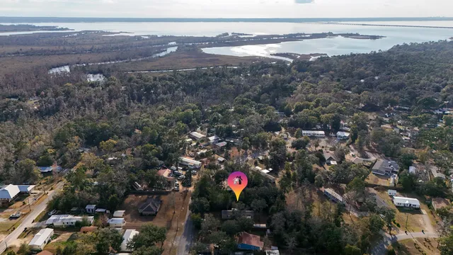an aerial view of house with yard and mountain view