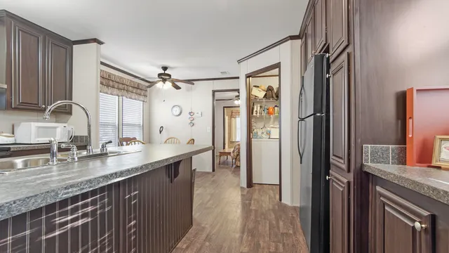 a kitchen with counter top space and wooden floor