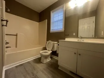 en empty room with windows and fan