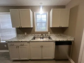 a stove top oven sitting inside of a kitchen