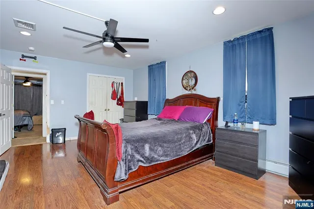 a bed room with a bed closet and a mirror