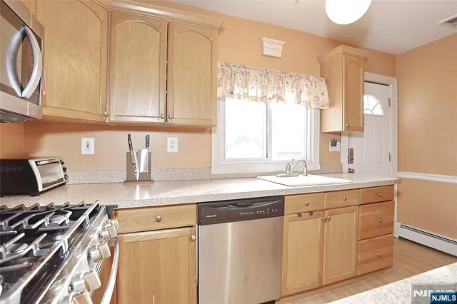 a kitchen with cabinets and window