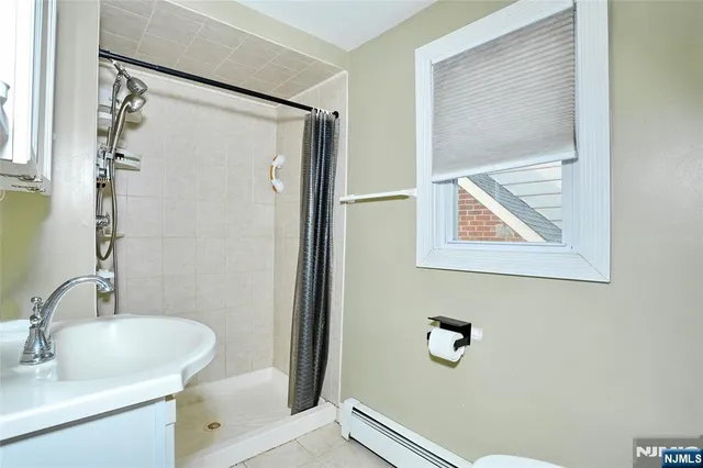 a bathroom with a shower and a sink