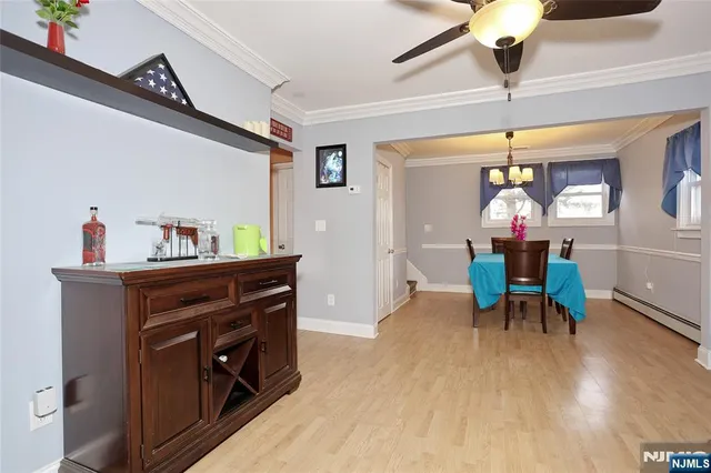 a view of a dining room with furniture and chandelier