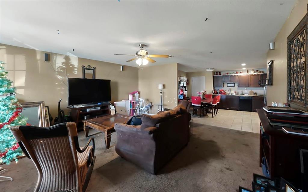 4920 Peachtree Road Balch Springs, TX 75180 - Photo 2 of 7 a living room with furniture and a flat screen tv