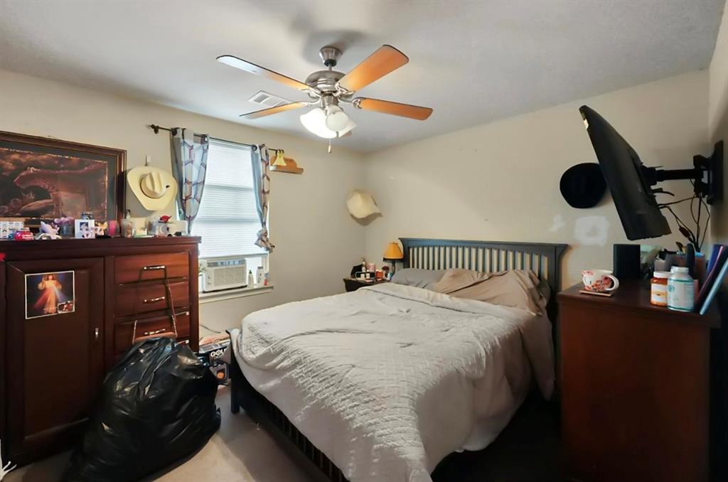 4920 Peachtree Road Balch Springs, TX 75180 - Photo 5 of 7 a bed room with a bed and dresser