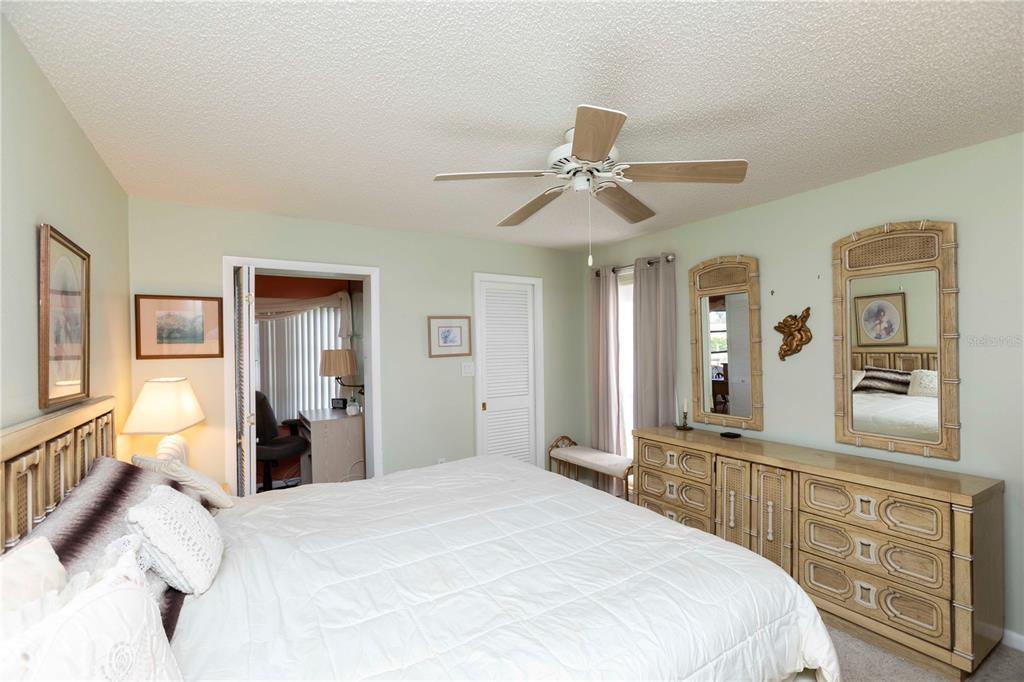 4533 Marine Parkway, Unit 206 New Port Richey, FL 34652 - Photo 11 of 22 a bedroom with a large bed and a chandelier