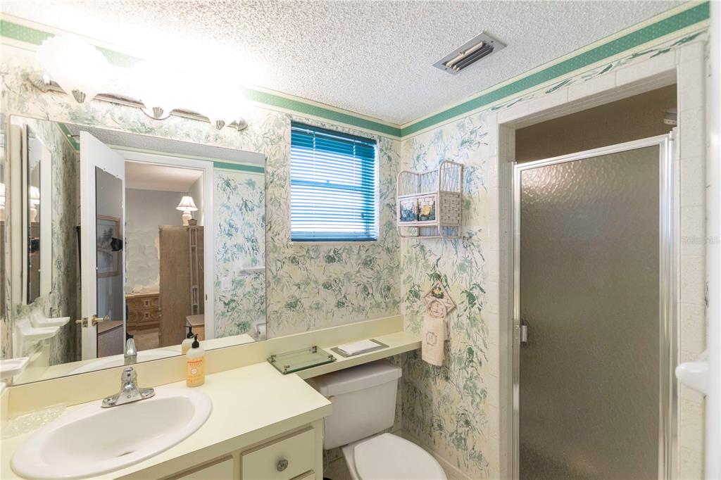 4533 Marine Parkway, Unit 206 New Port Richey, FL 34652 - Photo 13 of 22 a bathroom with a sink toilet and shower