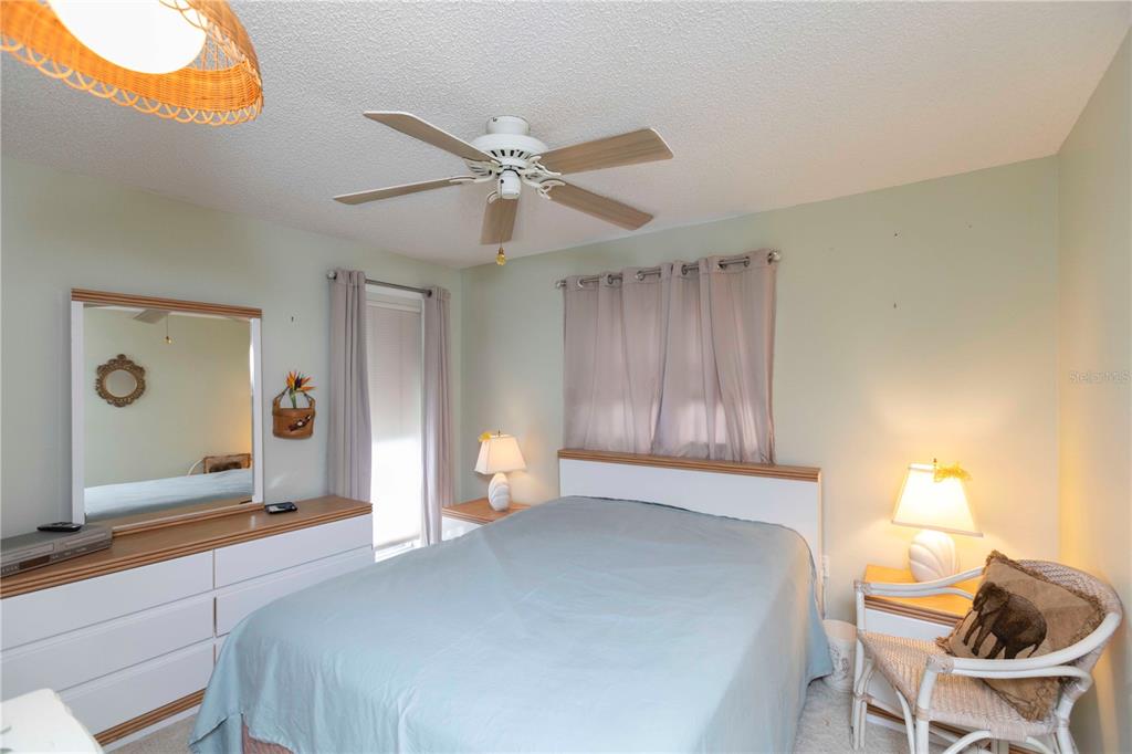 4533 Marine Parkway, Unit 206 New Port Richey, FL 34652 - Photo 14 of 22 a bedroom with a bed and a chandelier