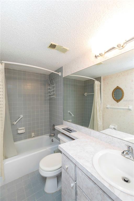 4533 Marine Parkway, Unit 206 New Port Richey, FL 34652 - Photo 15 of 22 a bathroom with a sink a toilet and shower