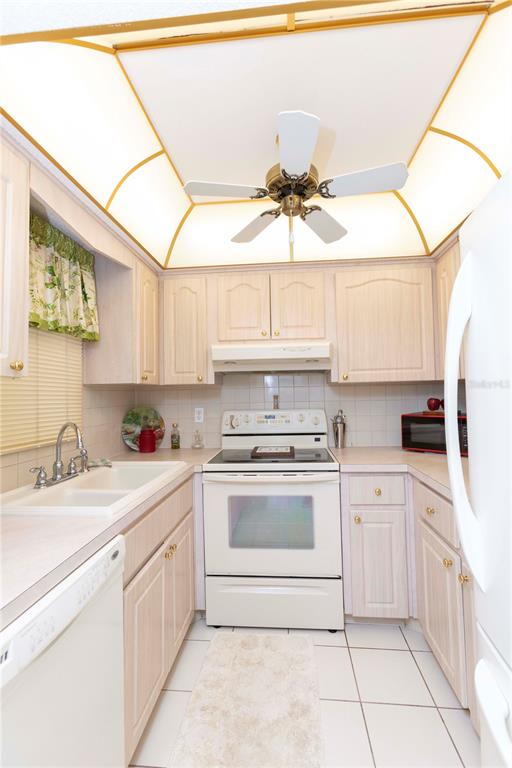 4533 Marine Parkway, Unit 206 New Port Richey, FL 34652 - Photo 4 of 22 a kitchen with a sink cabinets and window