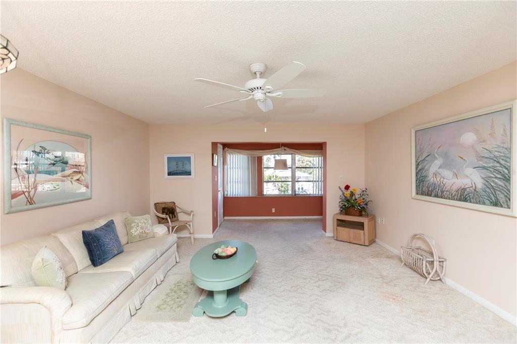 4533 Marine Parkway, Unit 206 New Port Richey, FL 34652 - Photo 7 of 22 a living room with furniture and a window