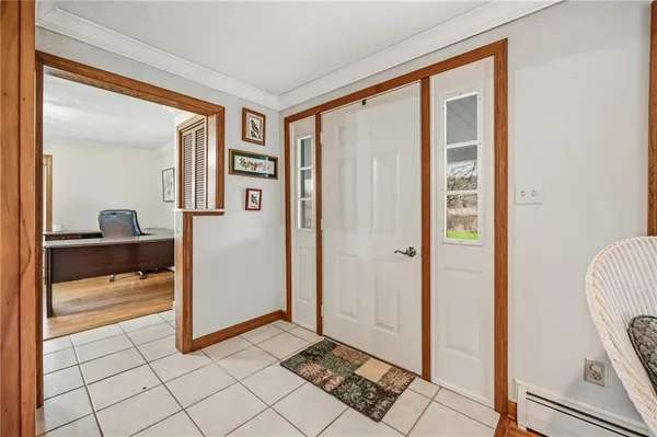 a view of a hallway with bathroom and mirror