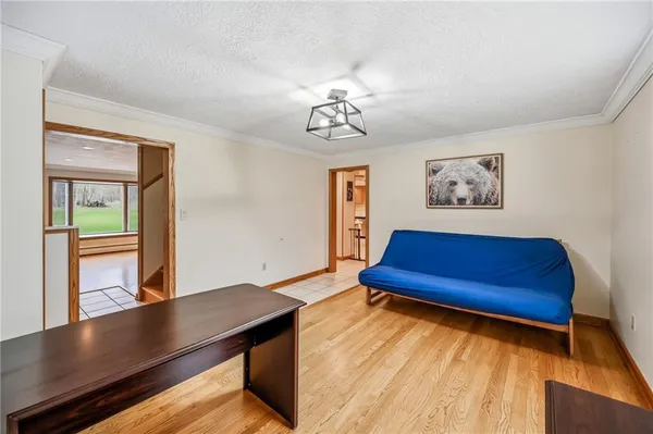 a view of a room with furniture and wooden floor