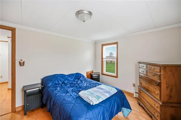 a bedroom with a bed dresser and a window
