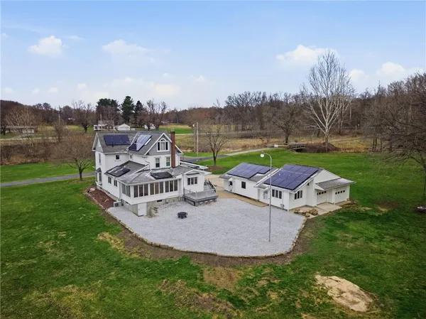 a view of a house with a yard and sitting area