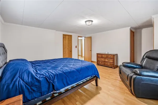 a bedroom with a bed couch and a window