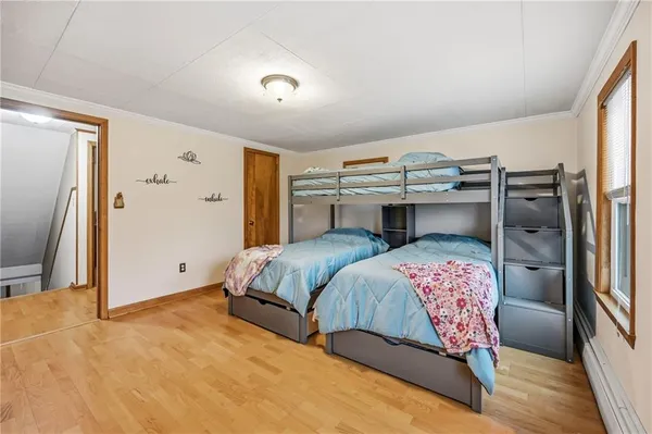 a bedroom with a bed and a flat tv screen