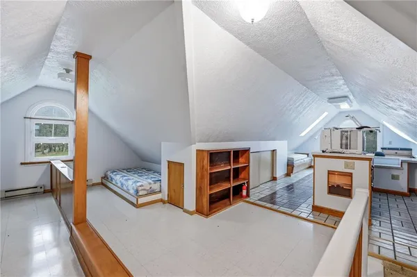 a living room with furniture and a book shelf