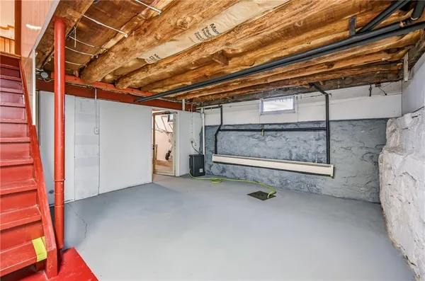 a view of a room with wooden walls and windows