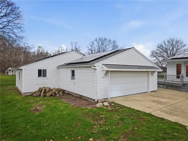 a view of a house with backyard and deck