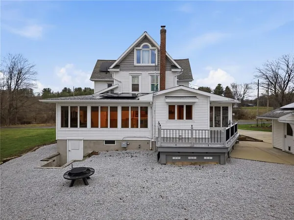 a view of a house with a small deck