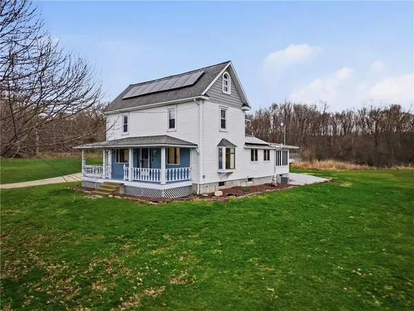 a front view of a house with a garden