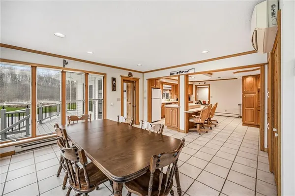 a dining room with furniture and a floor to ceiling window