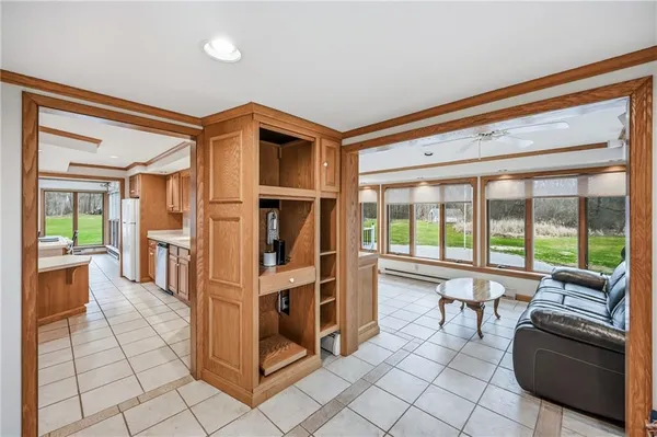 a view of living room with furniture and large windows