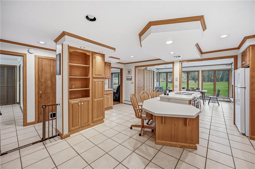 6238 Huron Street Transfer, PA 16154 - Photo 9 of 48 a dining hall with stainless steel appliances kitchen island granite countertop a refrigerator and a sink
