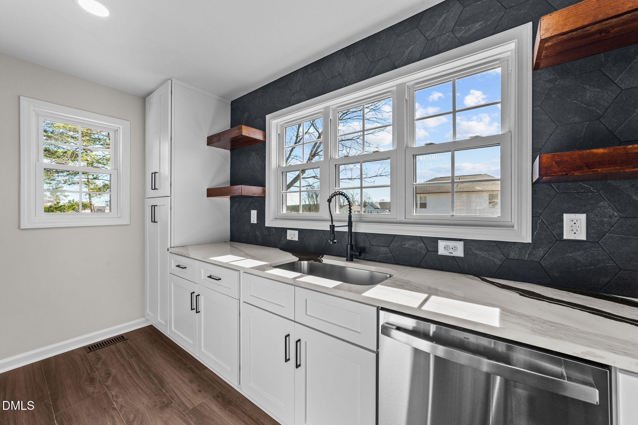 934 Old Zebulon Road Wendell, NC 27591 - Photo 12 of 26 a kitchen with stainless steel appliances granite countertop a sink a stove and a wooden floor