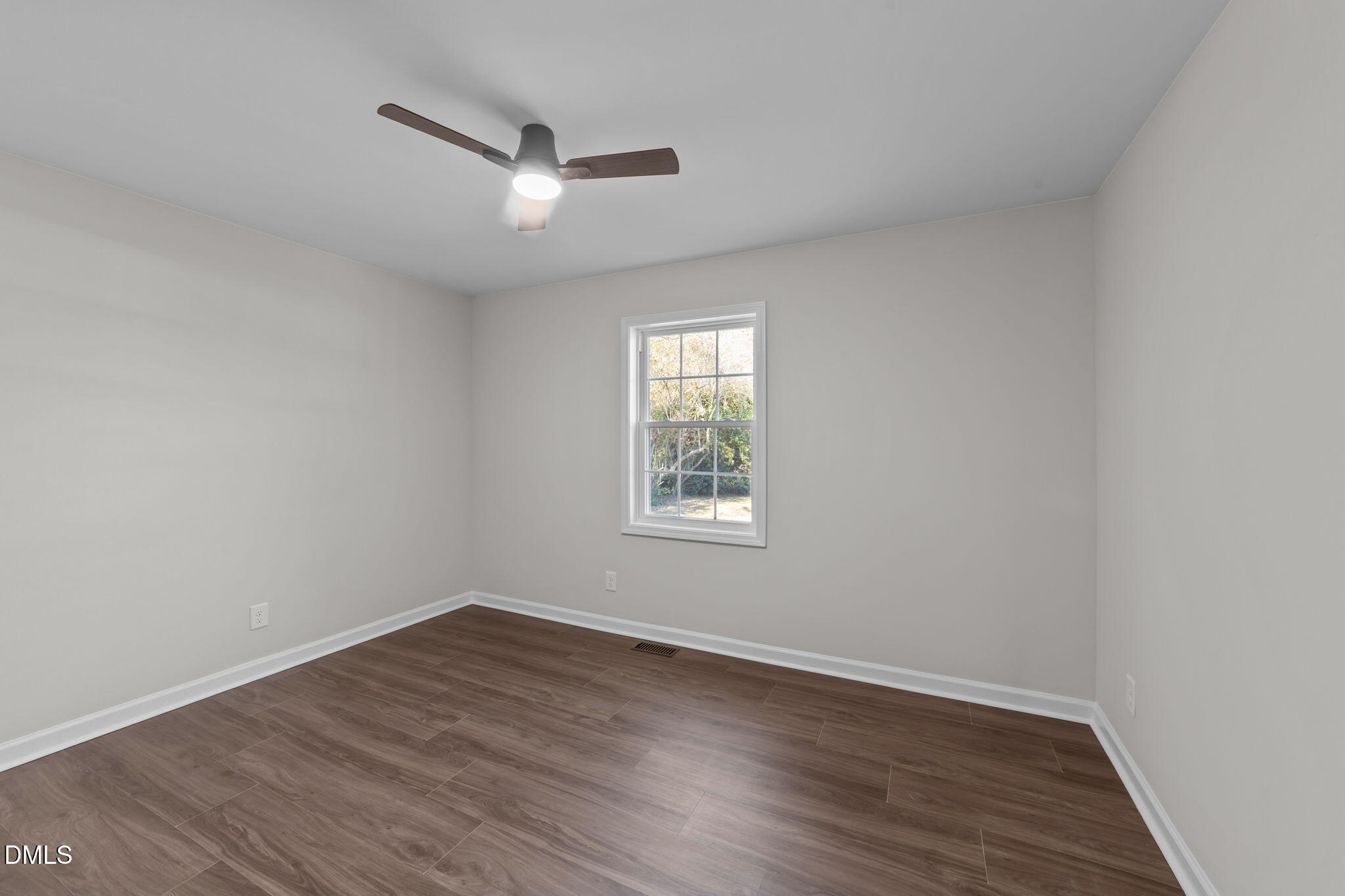 934 Old Zebulon Road Wendell, NC 27591 - Photo 14 of 26 an empty room with wooden floor and windows