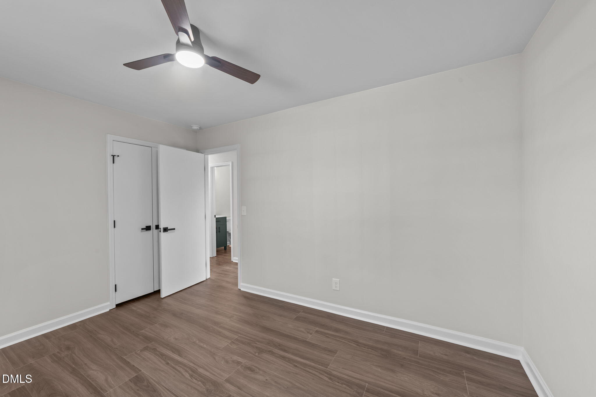 934 Old Zebulon Road Wendell, NC 27591 - Photo 15 of 26 an empty room with wooden floor and ceiling fan