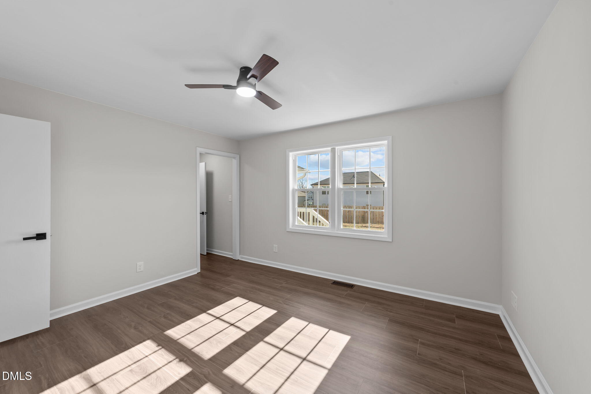934 Old Zebulon Road Wendell, NC 27591 - Photo 17 of 26 a view of an empty room with a window and wooden floor
