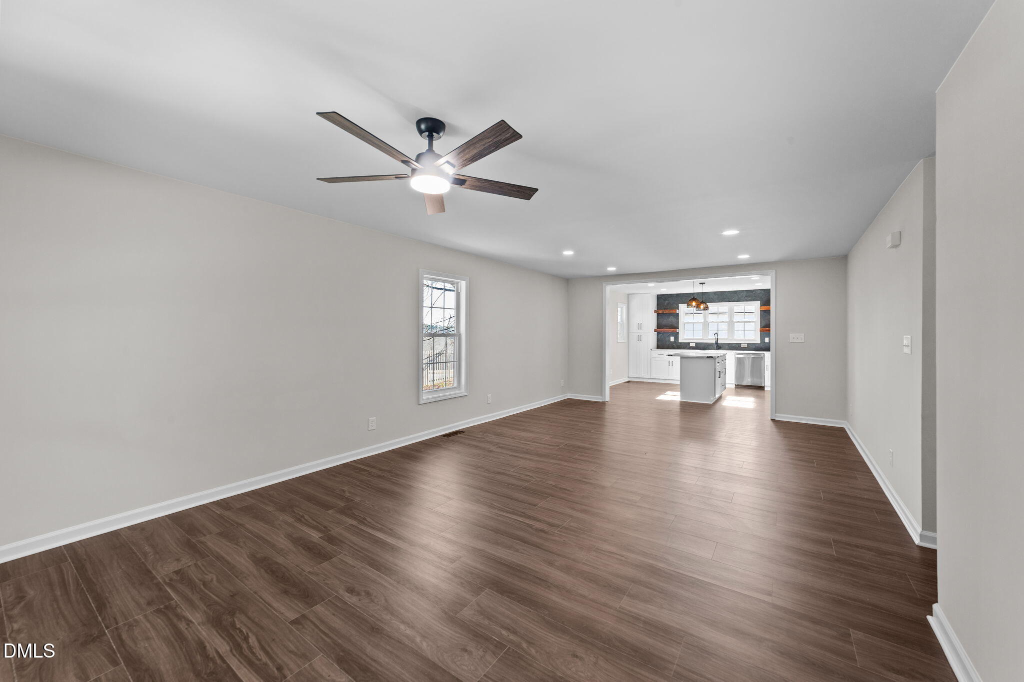 934 Old Zebulon Road Wendell, NC 27591 - Photo 4 of 26 a view of an empty room with a window and wooden floor