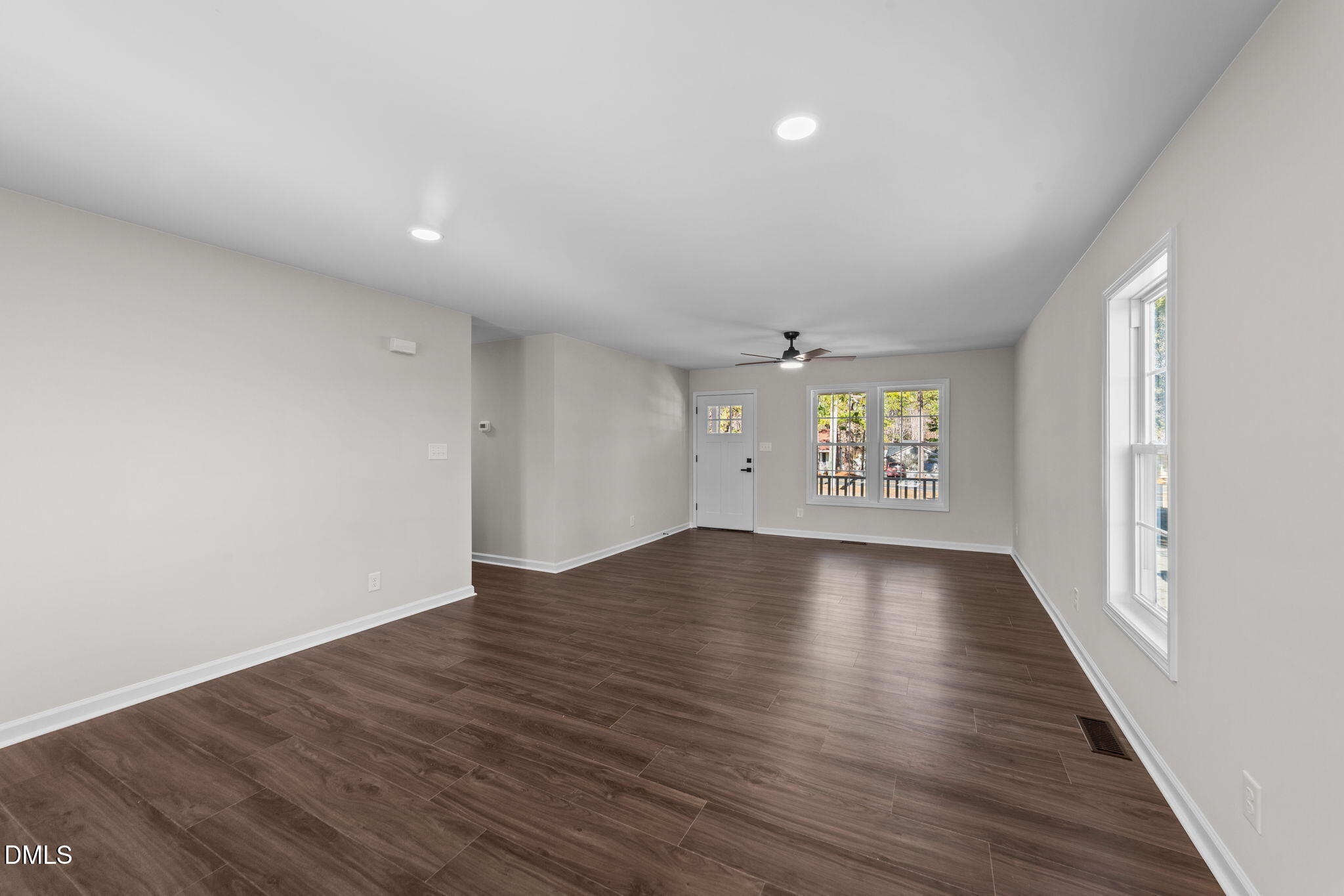 934 Old Zebulon Road Wendell, NC 27591 - Photo 6 of 26 an empty room with wooden floor and windows