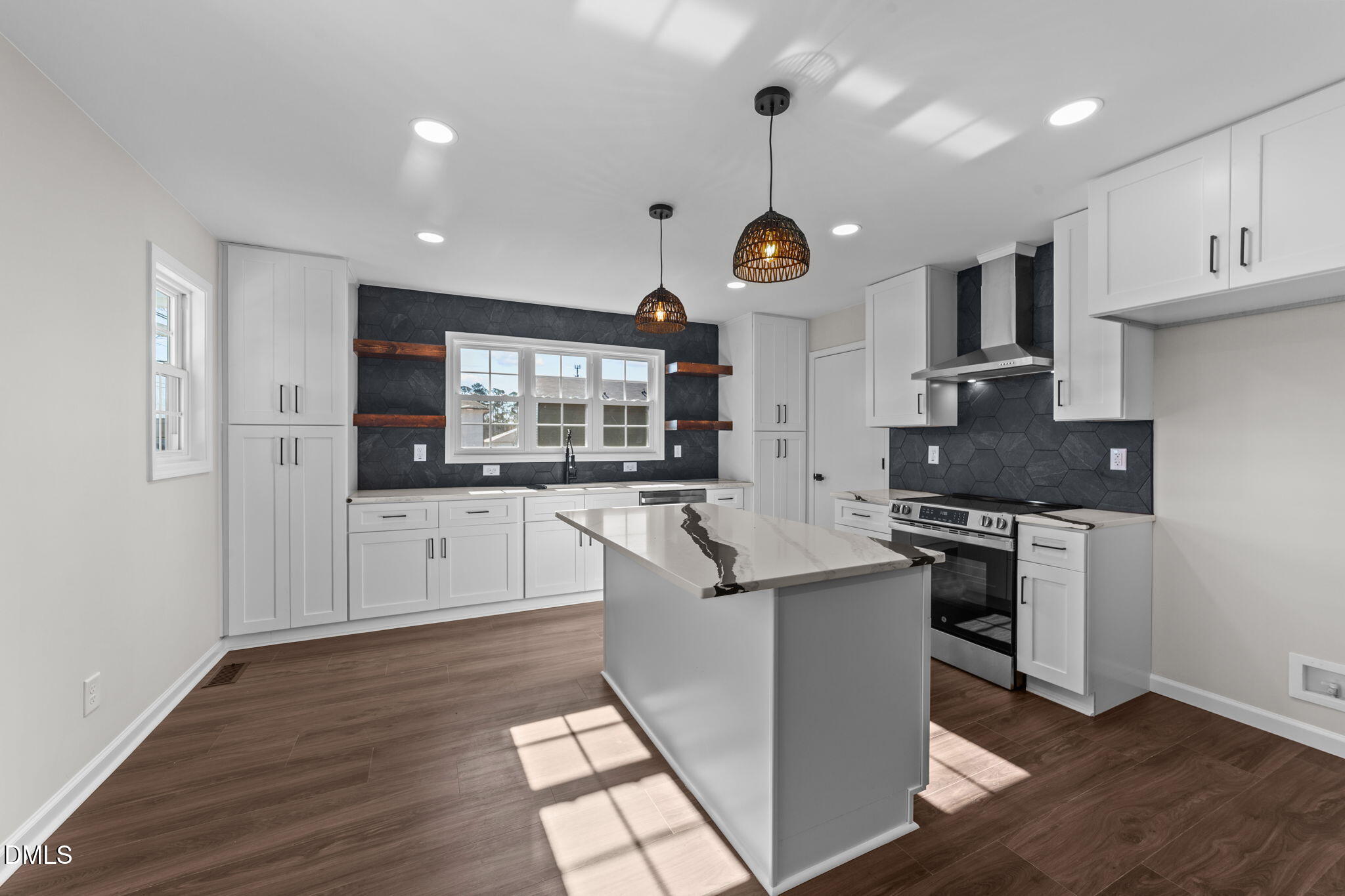 934 Old Zebulon Road Wendell, NC 27591 - Photo 7 of 26 a kitchen with stainless steel appliances kitchen island granite countertop a stove a sink and a refrigerator