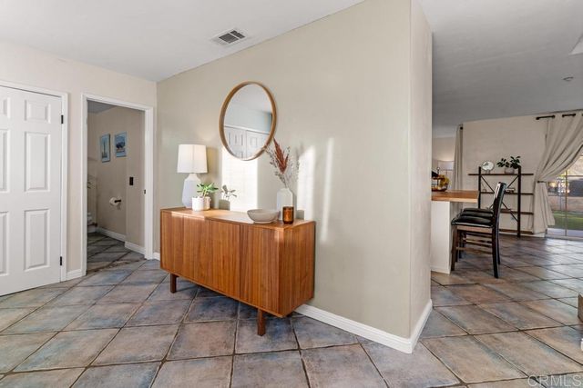 a kitchen with a refrigerator a stove top oven a sink dishwasher and white cabinets with wooden floor