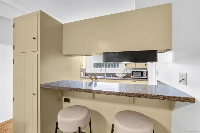 a kitchen with a sink a stove and a refrigerator