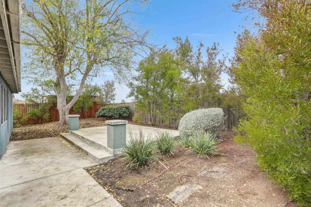 a backyard of a house with table and chairs