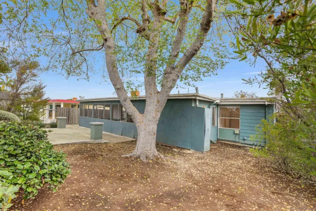 a view of a house with a tree